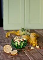 Easter still life,almonds in white chocolate and green easter eggs yellow tulips photo