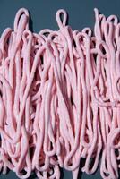 pink tarama pasta on a gray plate squeezed out of a cooking bag,creative texture photo