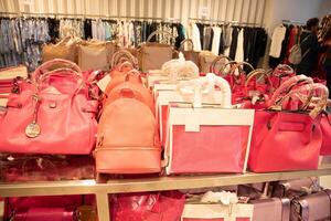 variety bag collection in store on counter pink magenta trendy pantone color photo