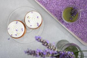 Two mousse cakes decorated with lavender flowers and matcha green tea photo