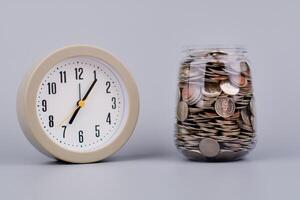 Money and time savings in a glass bottle, financial planning and investing in the stock market. photo