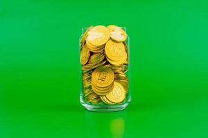 Saving gold in glass investment bottles and stocks, cash flow, financial growth and investing in the stock market. photo