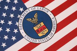 KYIV, UKRAINE - MARCH 9, 2024 US Department of Labor seal on United States of America flag photo