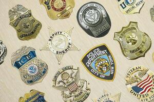 KYIV, UKRAINE - MARCH 9, 2024 Badges of different United States police departments printed on paper photo