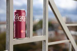 KYIV, UKRAINE - 4 MAY, 2023 Coca cola soft drink brand tin can with cherry flavour photo