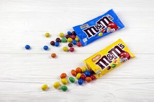 KHARKIV, UKRAINE - JANUARY 2, 2021 M and Ms colorful button shaped chocolate candies. Multi colored chocolates each of which has the letter m printed in lower case in white photo