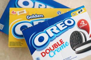 KYIV, UKRAINE - 4 MAY, 2023 Oreo double creme, strawberry cheesecake and golden sandwich cookies with cream filling in brand packs photo