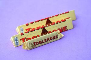 KYIV, UKRAINE - OCTOBER 31, 2023 Yellow Toblerone Chocolate Bar. Toblerone originated in Switzerland around 1908 photo