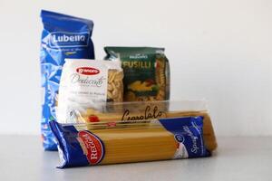 KYIV, UKRAINE - 4 MAY, 2023 Few packs of italian macaroni from differend famous brands and manufacturers photo