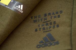 KYIV, UKRAINE - 4 MAY, 2023 Adidas company logo on new brand clothes photo
