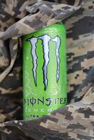 KYIV, UKRAINE - 4 MAY, 2023 Monster energy drink ultra paradise in green tin can with Monster energy drink logo photo