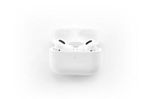 KYIV, UKRAINE - 4 MAY, 2023 Apple AirPods Pro on a white background. Wireless headphones in a charging case photo