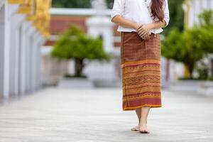 Buddhist asian woman is doing walking meditation around temple for peace and tranquil religion practice concept photo