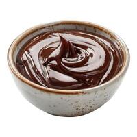 Bowl of chocolate sauce is sitting on a white background. The sauce is thick and rich, and it looks like it's ready to be drizzled over something. photo