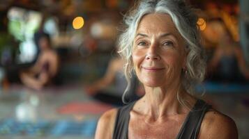 A woman with grey hair wearing a black tank top photo