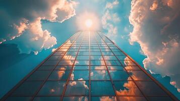 A tall building reaching towards clouds in the sky photo