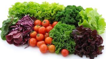 A mix of lettuce, tomatoes, and various vegetables piled together photo