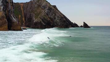 Drone flying low over ocean waves breaking near shore. video