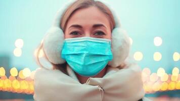 a woman wearing a face mask and ear muffs video