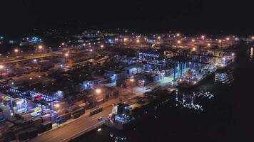 AERIAL Container ships are in the port at the quay wall at night video