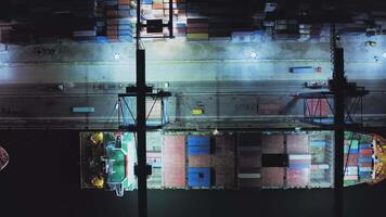 AERIAL Unloading of containers at night in the port. Container terminal video