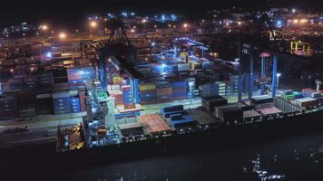 AERIAL Container ships are in the port at the quay wall at night video