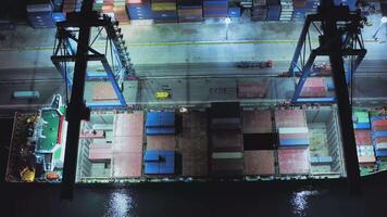 AERIAL Unloading of containers at night in the port. Container terminal video