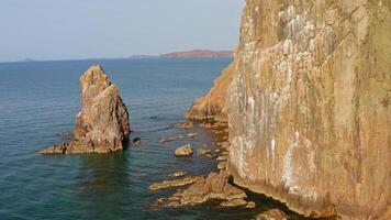 Two sea stacks in the sea. Abandoned lighthouse on top of a rocky island video