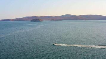 The motorboat moves quickly across the sea and splashes in the waves video