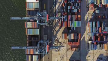 Aerial. cargo containers being unloaded by a gantry crane from a container ship video