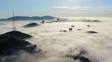 Drone view of the Vladivostok lowlands covered in morning sea mist at dawn video