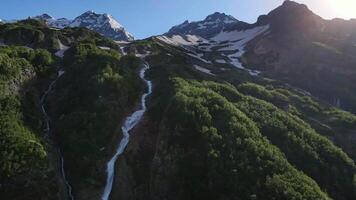 Aerial. Cascading falls and stunning mountain valley scenery video