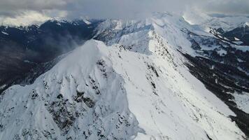 Alpine landscape of snowy mountain peaks from the air video