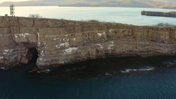 Aerial. Sea coast with beautiful high cliffs and cave. Cape Tobizina video