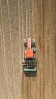 Top view of tractor sowing grain in the farm field. video