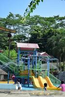 February 29, 2024. Magelang, Indonesia. playful, laughing, and enjoy kids in water park photo