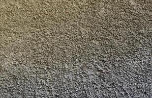 Plastered wall texture with rough relief mortar and light gray color photo