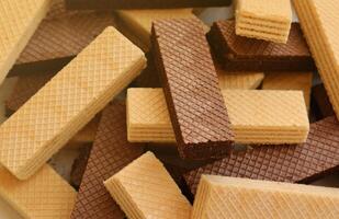 Stacked delicious chocolate wafers in large amount. Two different flavours of classic waffles photo