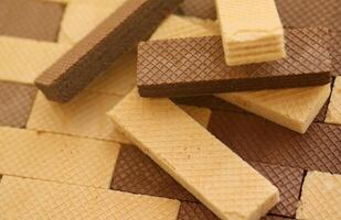 Stacked delicious chocolate wafers in large amount. Two different flavours of classic waffles photo