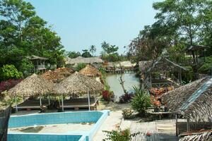 Simple buildings and huts made of wood and roofs made of sago leaves photo