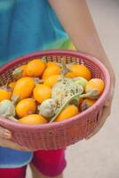 Fresh yellow eggplant stored in a red bowl photo