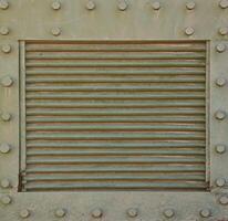 The texture of the wall of the tank, made of metal and reinforced with a multitude of bolts and rivets. Images of the covering of a combat vehicle from the Second World War photo