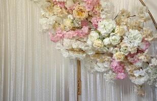 Faux pink plastic flowers hanging down in luxury white interior photo