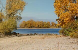 Beautiful autumn landscape with lake and multicoloral trees. Picturesque place with lake and tall trees photo