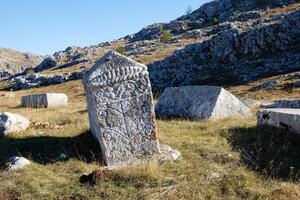 Stecci Medieval Tombstones Graveyards in Cengica Bara in Kalinovik, Bosnia and Herzegovina. Unesco site. The tombstones feature a wide range of decorative motifs and inscriptions. photo