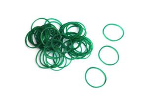 Elastic green rubber bands in ring or oval shape on white background. Concept, equipment that use for tie multiple objects together, use in office or household item that can be used in various purpose photo