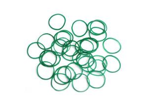 Elastic green rubber bands in ring or oval shape on white background. Concept, equipment that use for tie multiple objects together, use in office or household item that can be used in various purpose photo