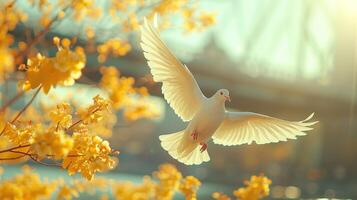 A white bird flies above a tree bursting with yellow flowers photo