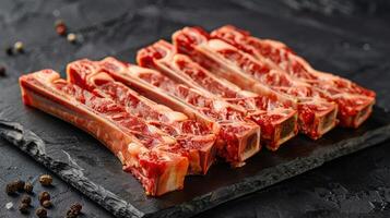 Arrangement of sliced meat on a slate board with various spices photo