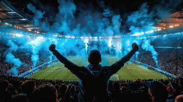 A man stands in front of a cheering crowd during a soccer game photo